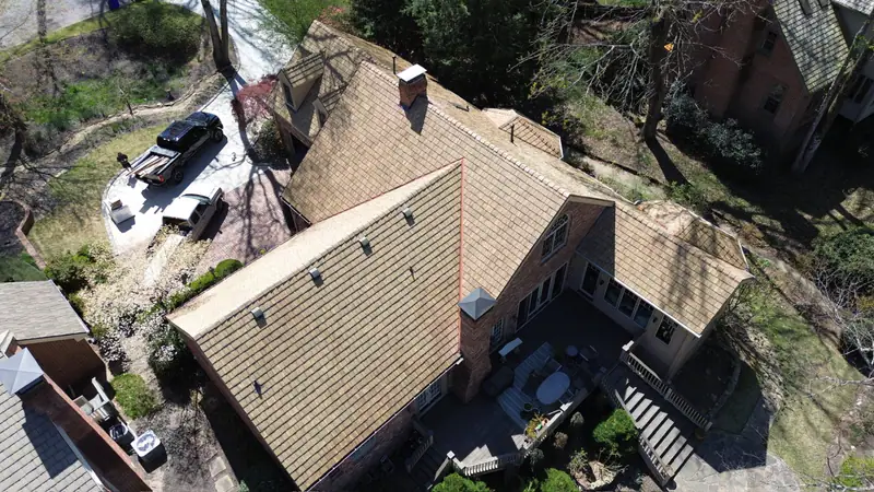 Brick home with a completed Brava synthetic cedar shake roof replacement
